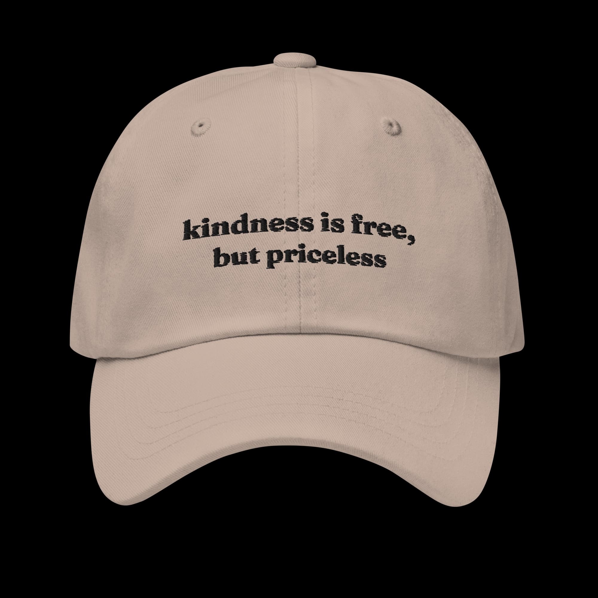 Stone-coloured classic dad cap with 'kindness is free, but priceless' embroidered across the front